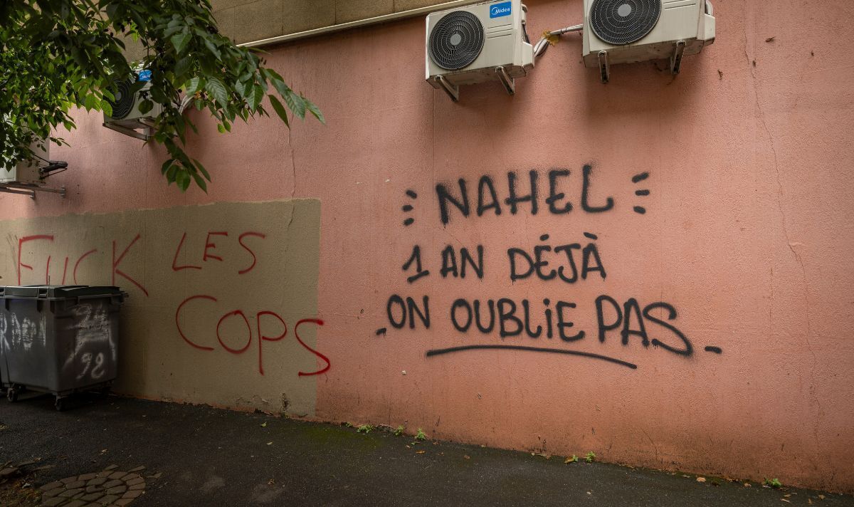 Anti-police graffiti alongside a tribute to Nahel Merzouk